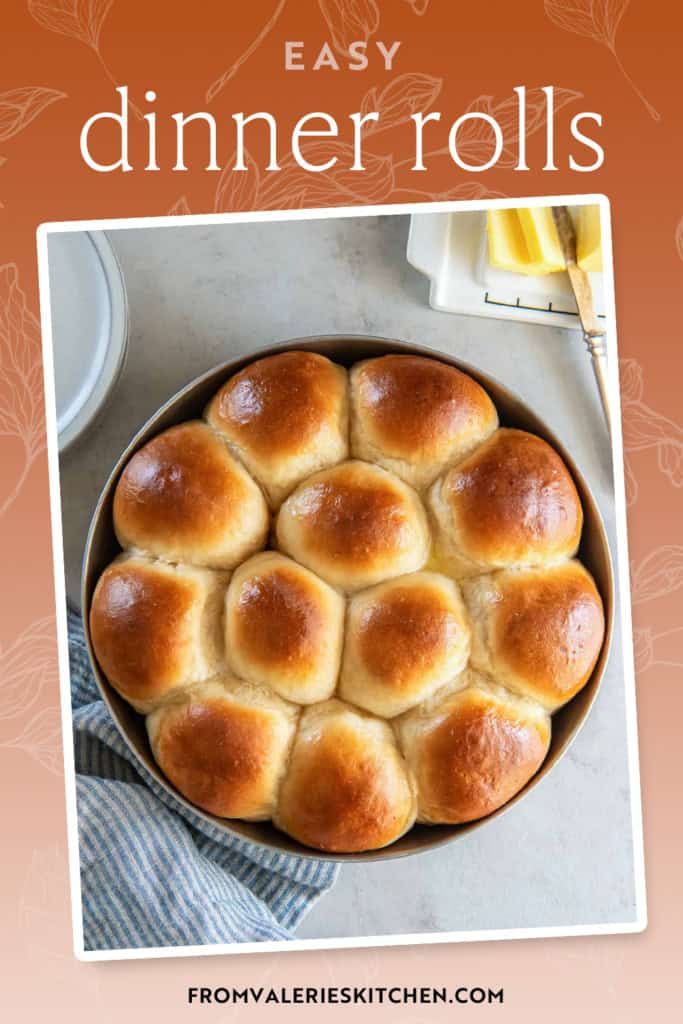 Dinner rolls in a round metal cake pan next to a butter dish with text overlay.