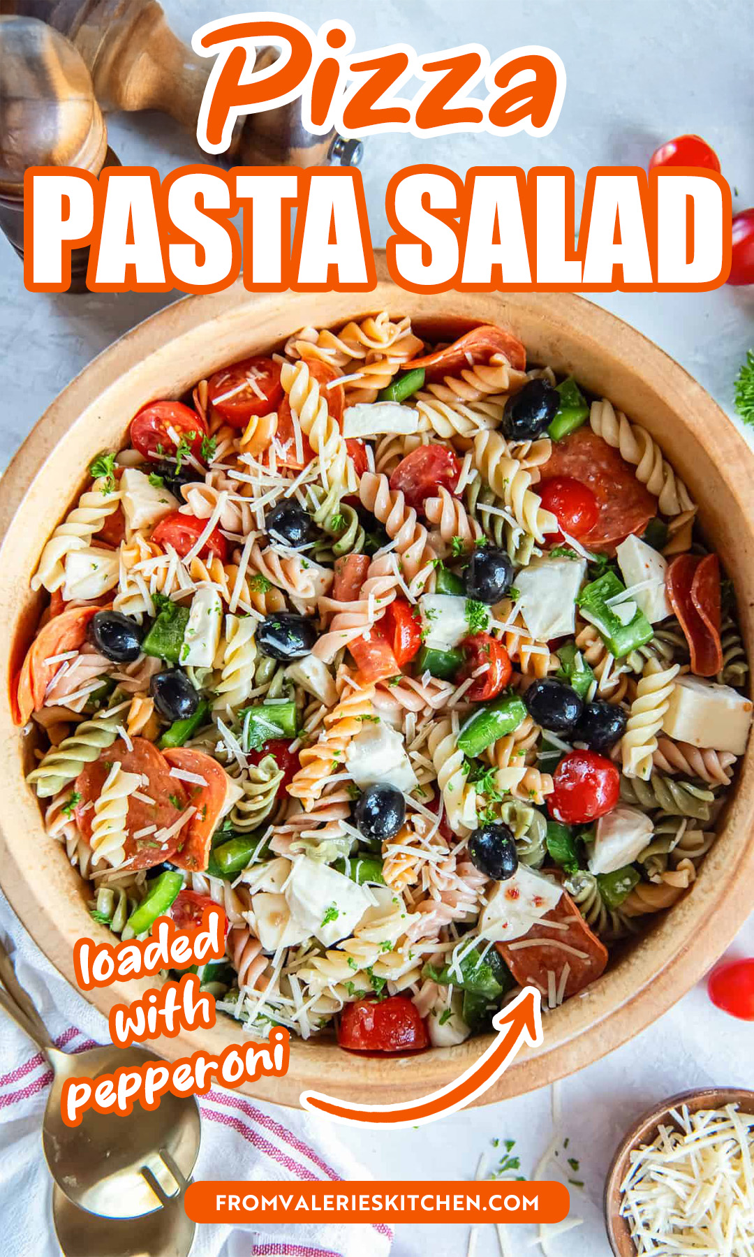 A wood bowl filled with pizza pasta salad with text overlay.