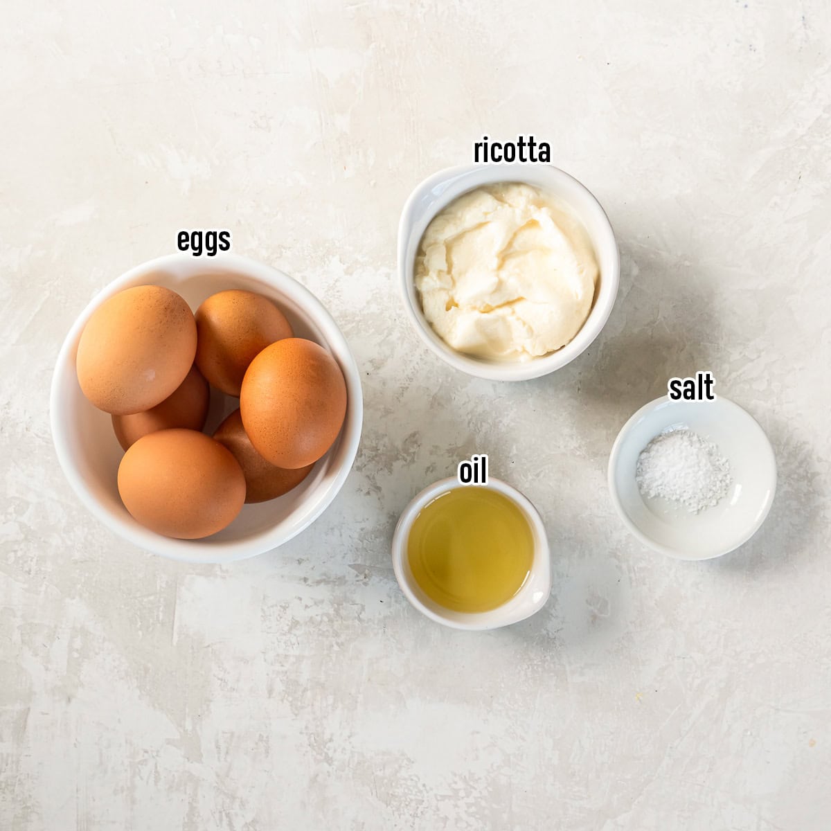 Eggs,ricotta cheese, oil, and salt in bowls with text overlay.