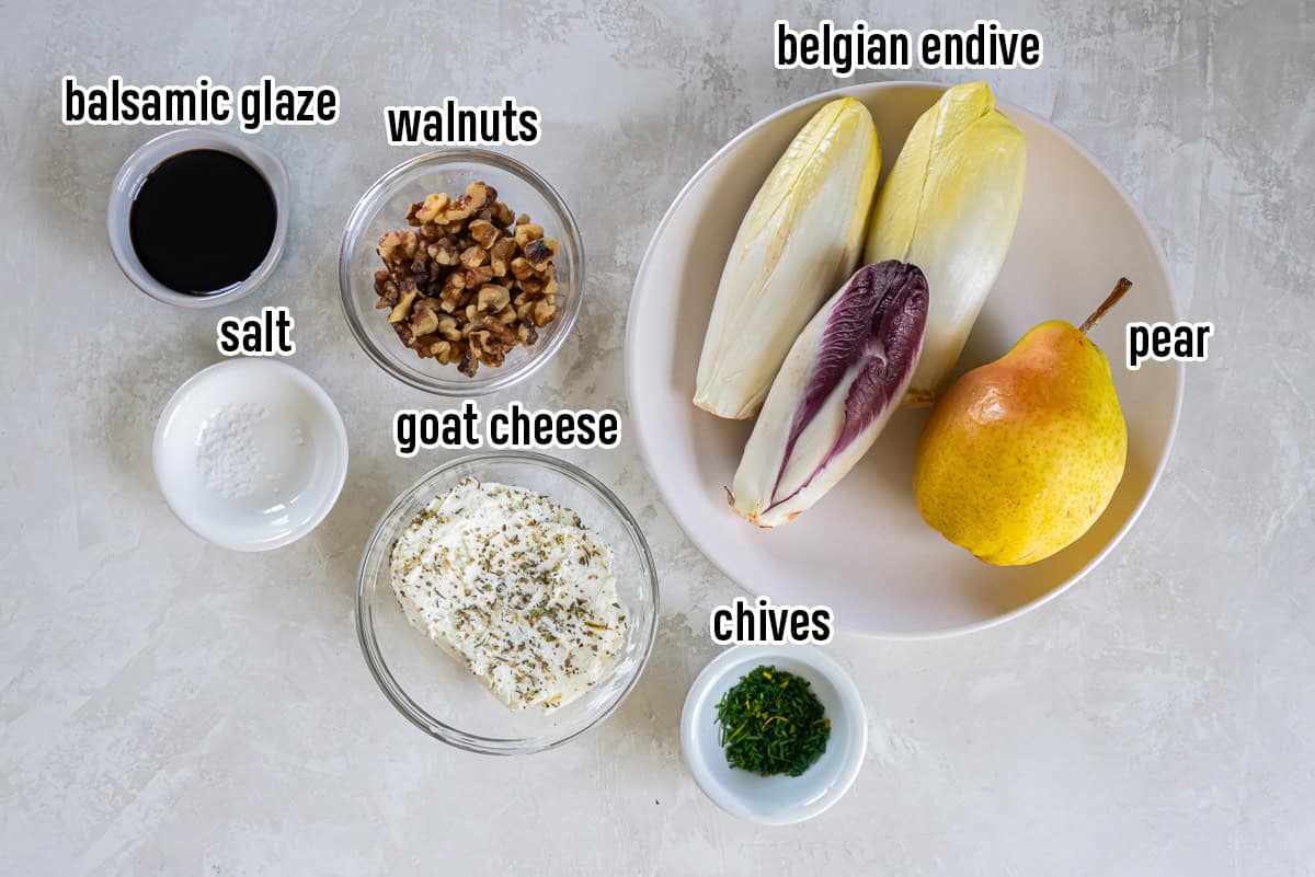Endive Appetizer with Goat Cheese and Pear 3 Belgian endive, goat cheese, pear, walnuts, balsamic glaze, and chives in bowls with text overlay.