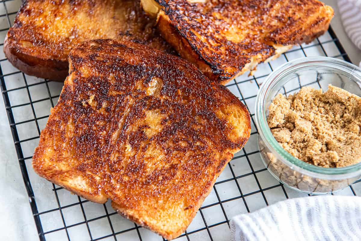 Brown Sugar Toast 4 Brown sugar toast on a wire rack next to a small bowl of brown sugar.