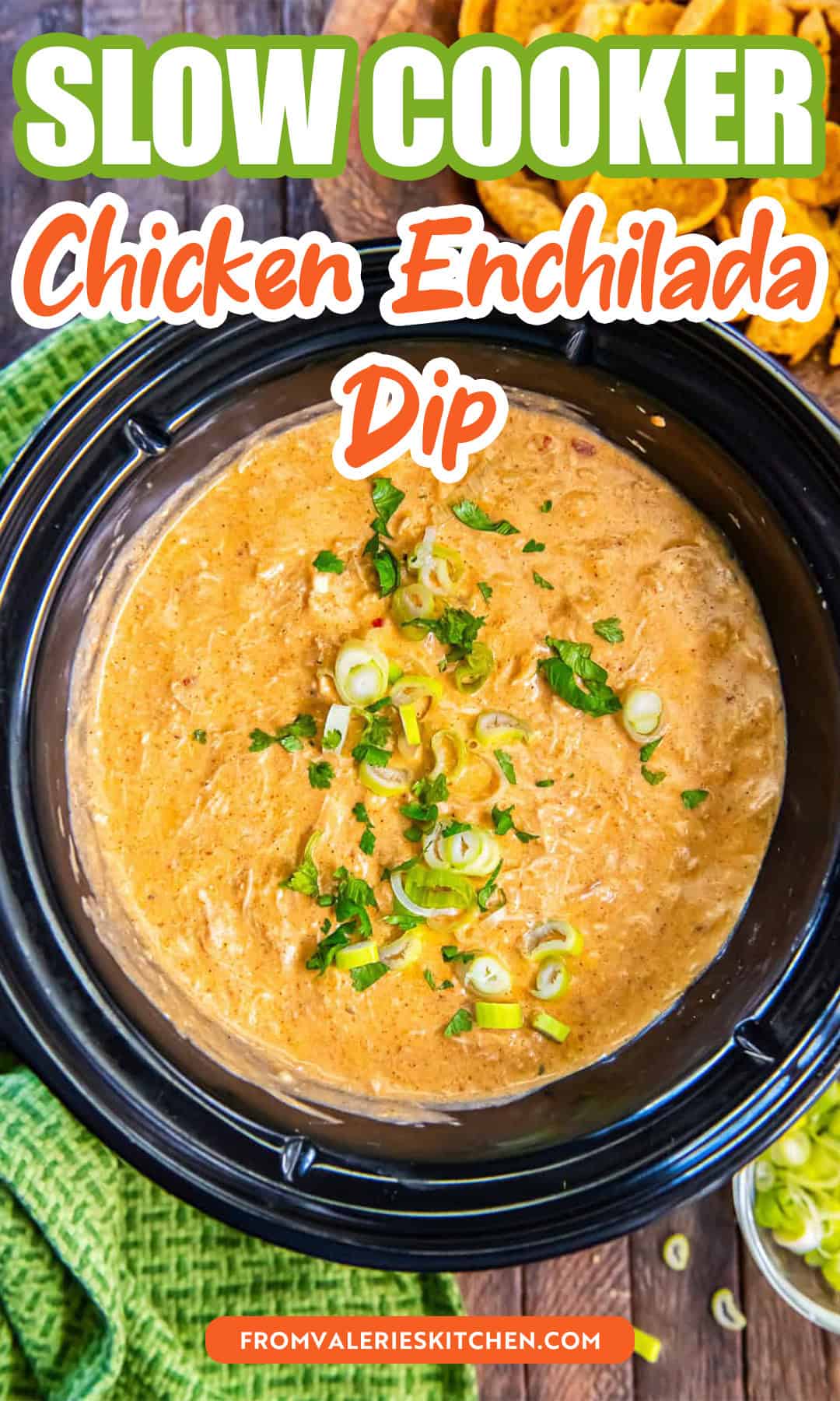 Chicken enchilada dip in a slow cooker topped with sliced green onions and cilantro with text overlay.