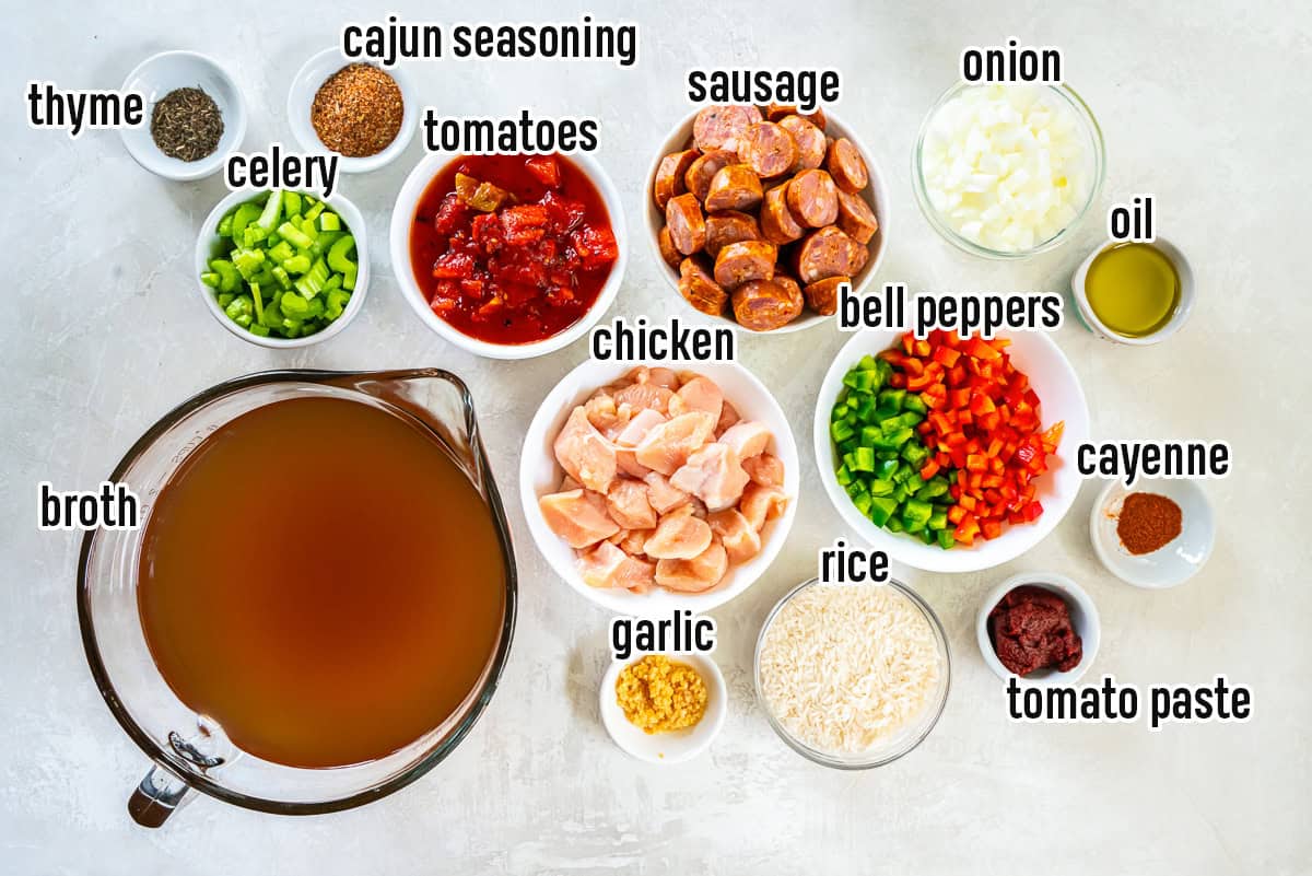 Chicken, sausage, tomatoes and other ingredients for Jambalaya Soup with text overlay.