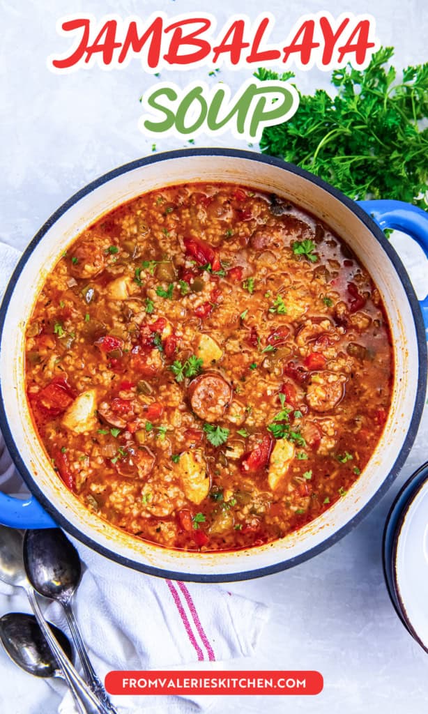 A Dutch oven of Jambalaya Soup with chunks of chicken and sliced sausage with text overlay.
