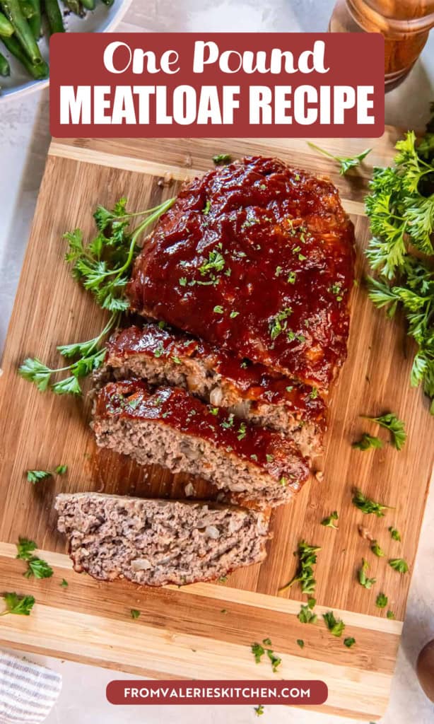 A small sliced meatloaf with glaze on a cutting board with text overlay.