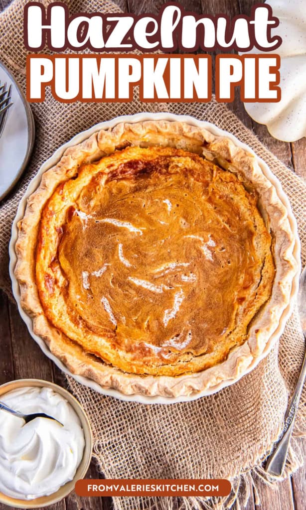Hazelnut pumpkin pie with a creamy swirl on top with text overlay.