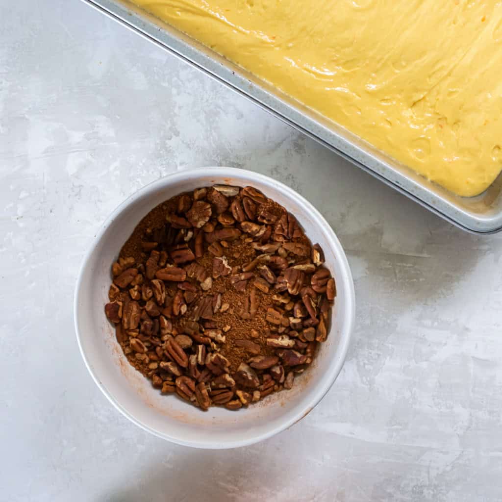 A pecan and sugar mixture in a small bowl.
