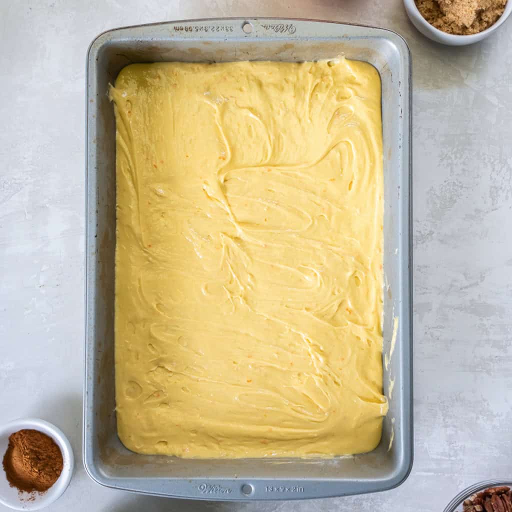 Cake batter in a metal baking pan.