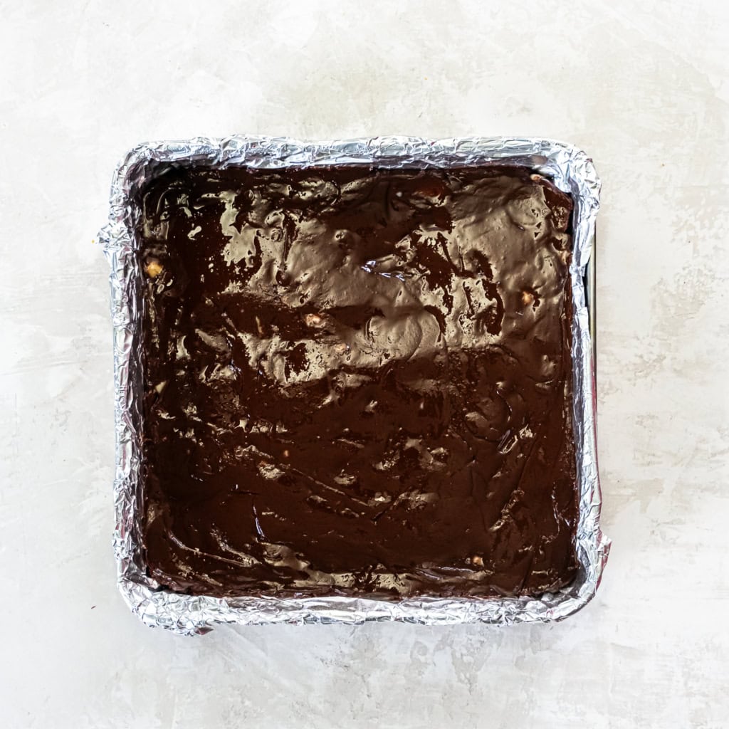 Macadmia nut fudge in a foil lined square pan.