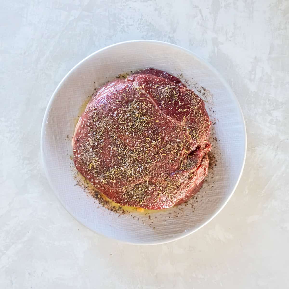 Sirloin tip roast coated with olive oil and roast beef seasoning before air frying.
