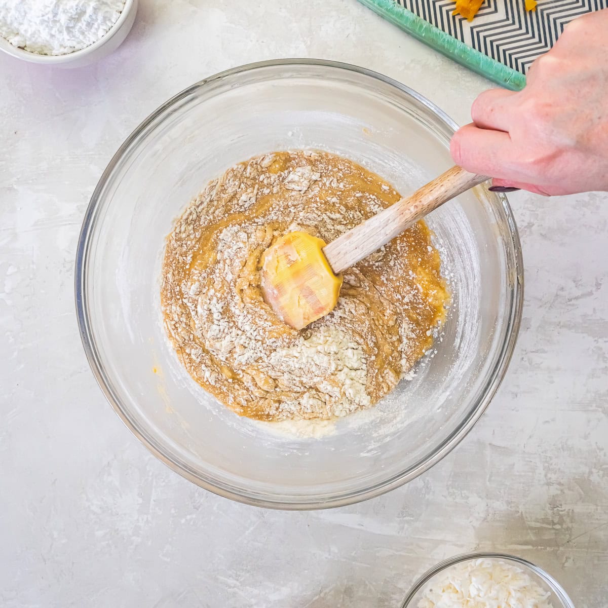 Dry ingredients being folded into apricot bar batter with a spatula.