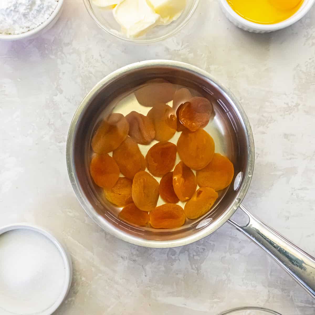 Dried apricots simmering in water to soften before chopping.