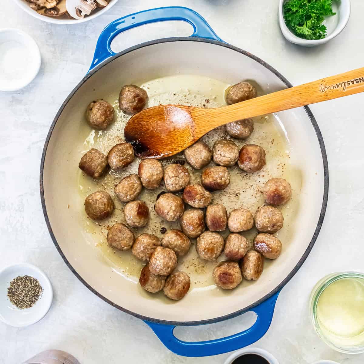 Frozen fully cooked meatballs browning in a little oil in the skillet.