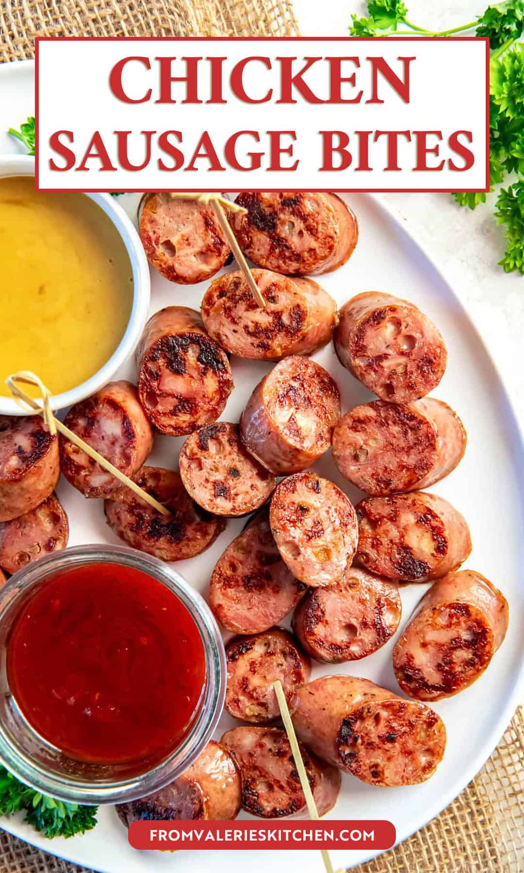 Chicken sausage bites browned in a skillet and arranged on a white platter with toothpicks, served with honey mustard and chili jam dipping sauces and fresh parsley garnish with text overlay.