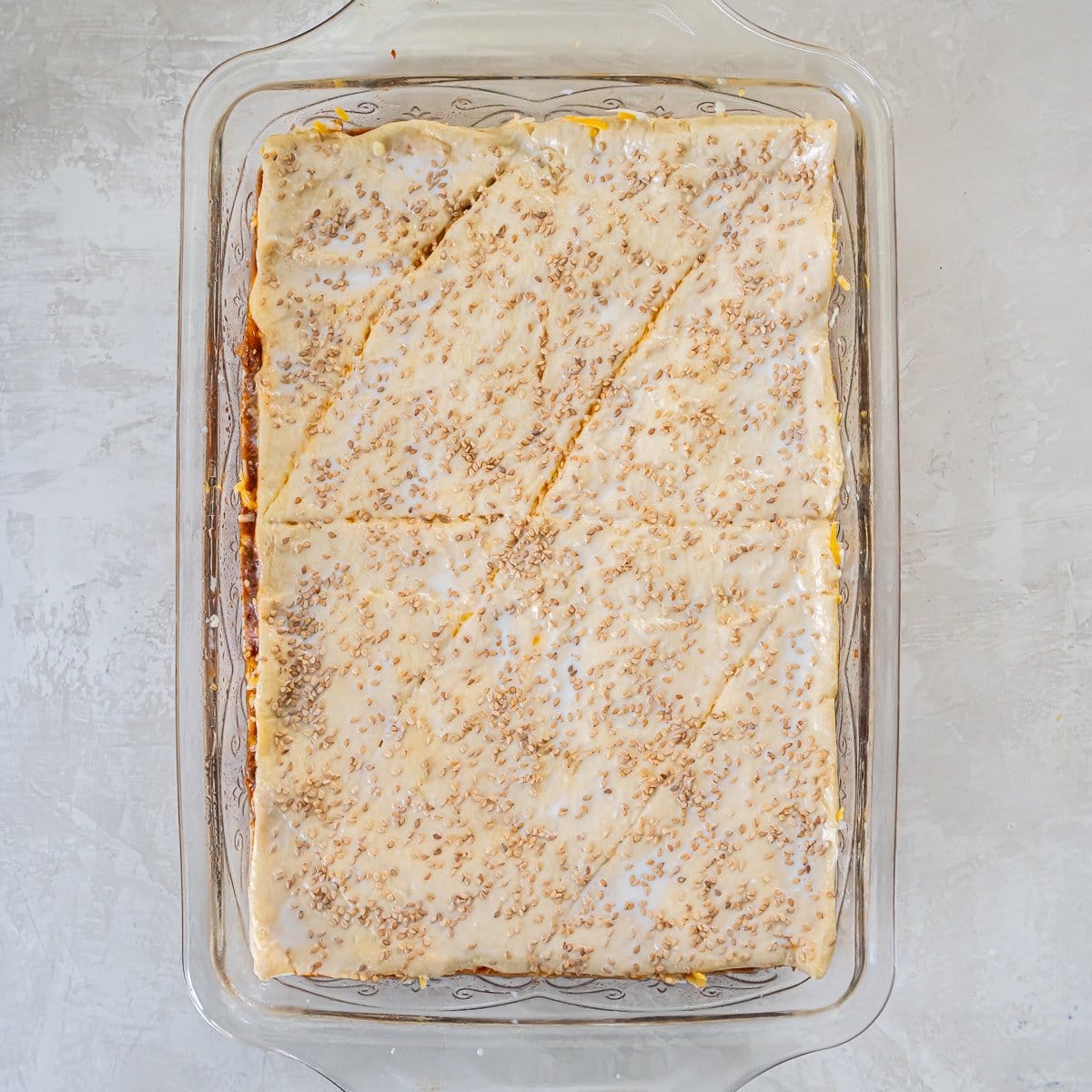 Top crust brushed with milk and sprinkled with sesame seeds before baking.