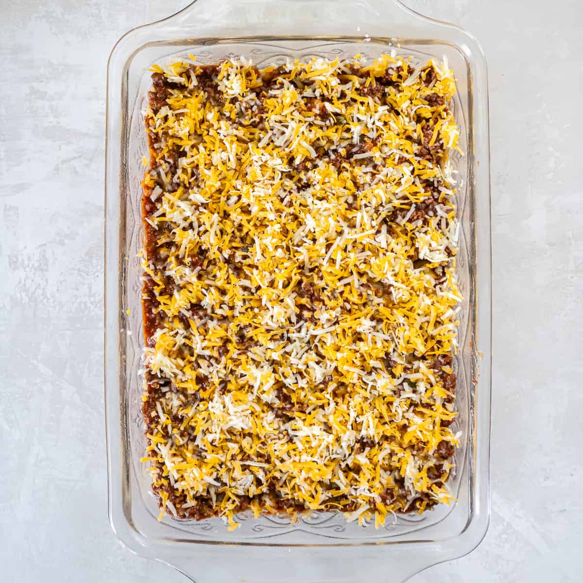 Shredded cheddar-jack cheese sprinkled evenly over the Sloppy Joe filling.