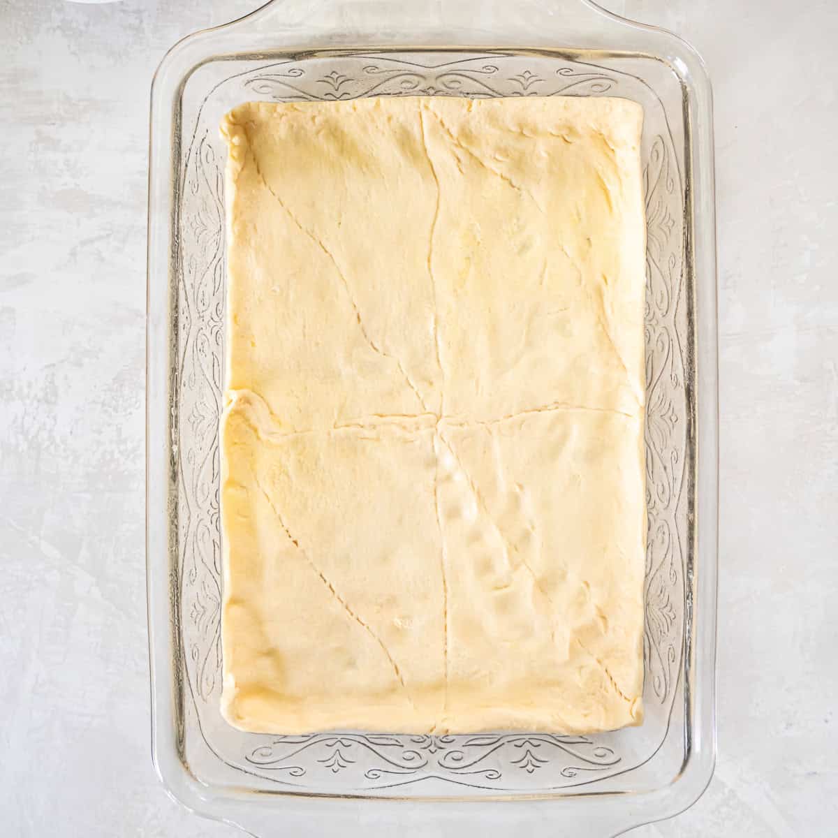 Crescent roll dough pressed into a 9&times;13-inch pan to form the bottom crust for Sloppy Joe Squares.