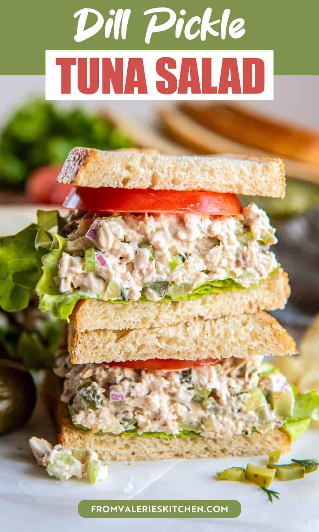 Stacked dill pickle tuna salad sandwich layered with crisp lettuce and fresh tomato on sliced bread with title text overlay.