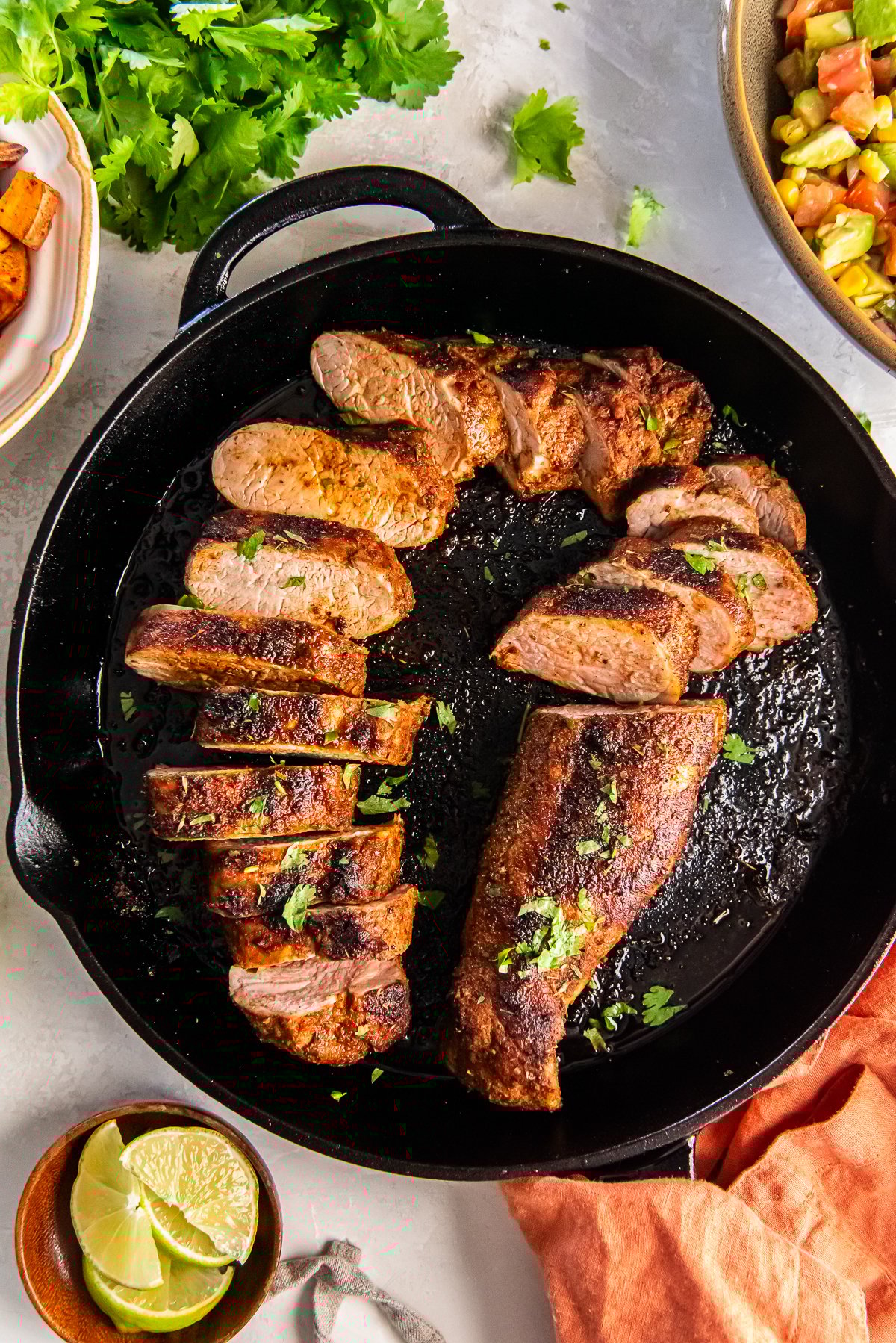 Southwestern spiced pork tenderloin, sliced and cooked until juicy in a cast iron skillet.