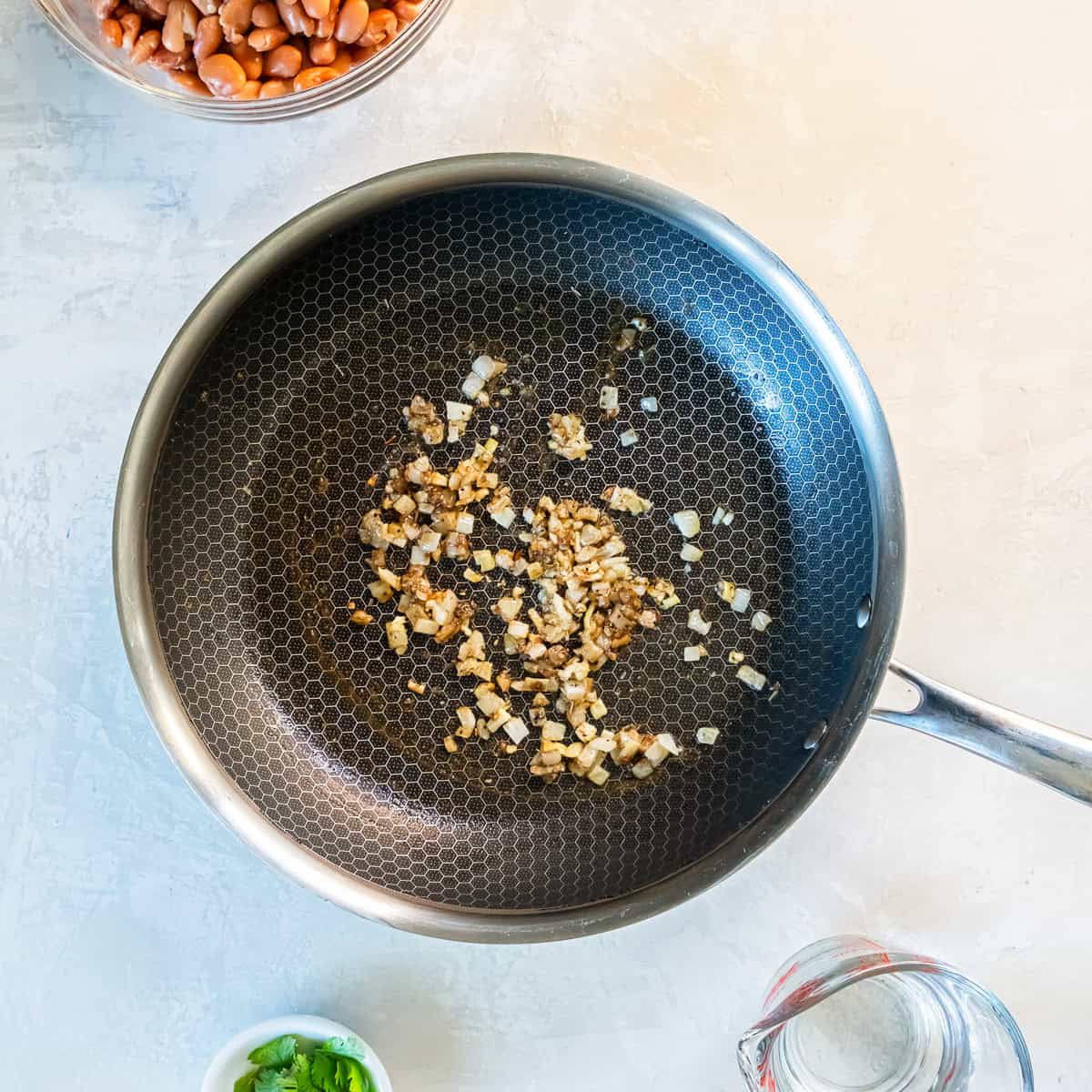 Onion and garlic sautéed with spices in a skillet until softened and fragrant