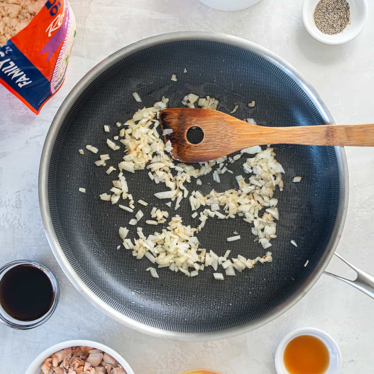 Diced yellow onion saut&eacute;ing in oil in a large skillet.