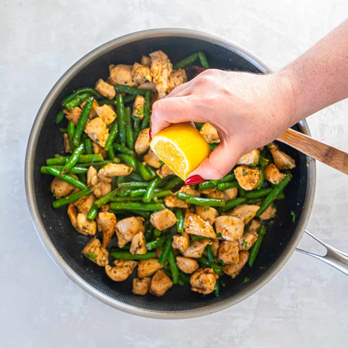 Cooked chicken added back to the skillet with green beans and finished with fresh lemon juice.