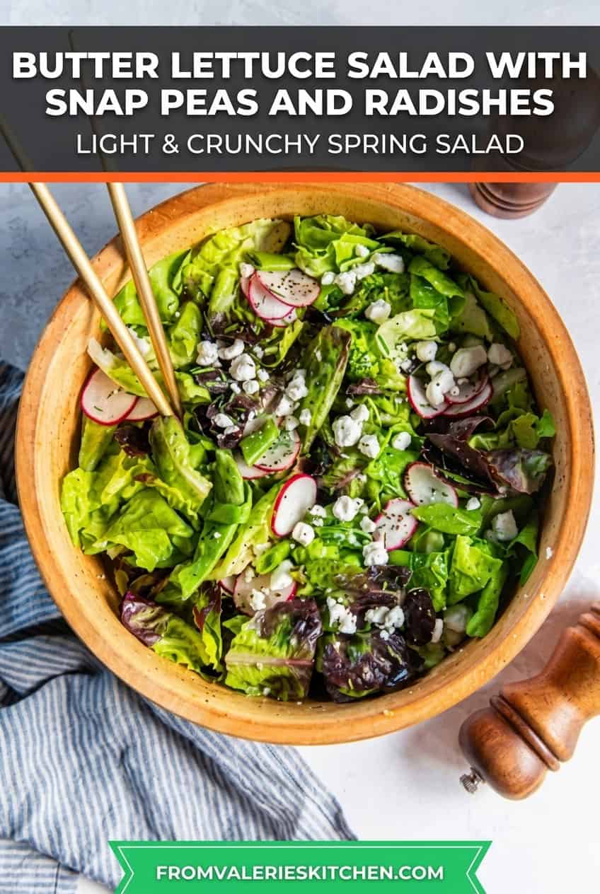 Butter lettuce salad with snap peas, radishes, goat cheese, and chives in a wooden salad bowl with salad spoons on a light countertop with text overlay.