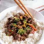 Ground beef teriyaki bowls served over rice with stir-fry vegetables and green onions.