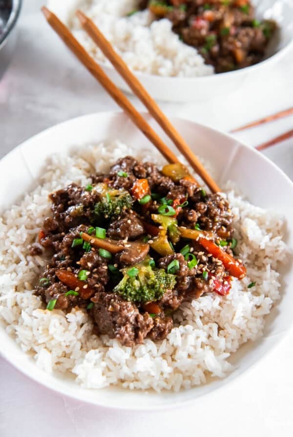 Ground beef teriyaki bowls served over rice with stir-fry vegetables and green onions.