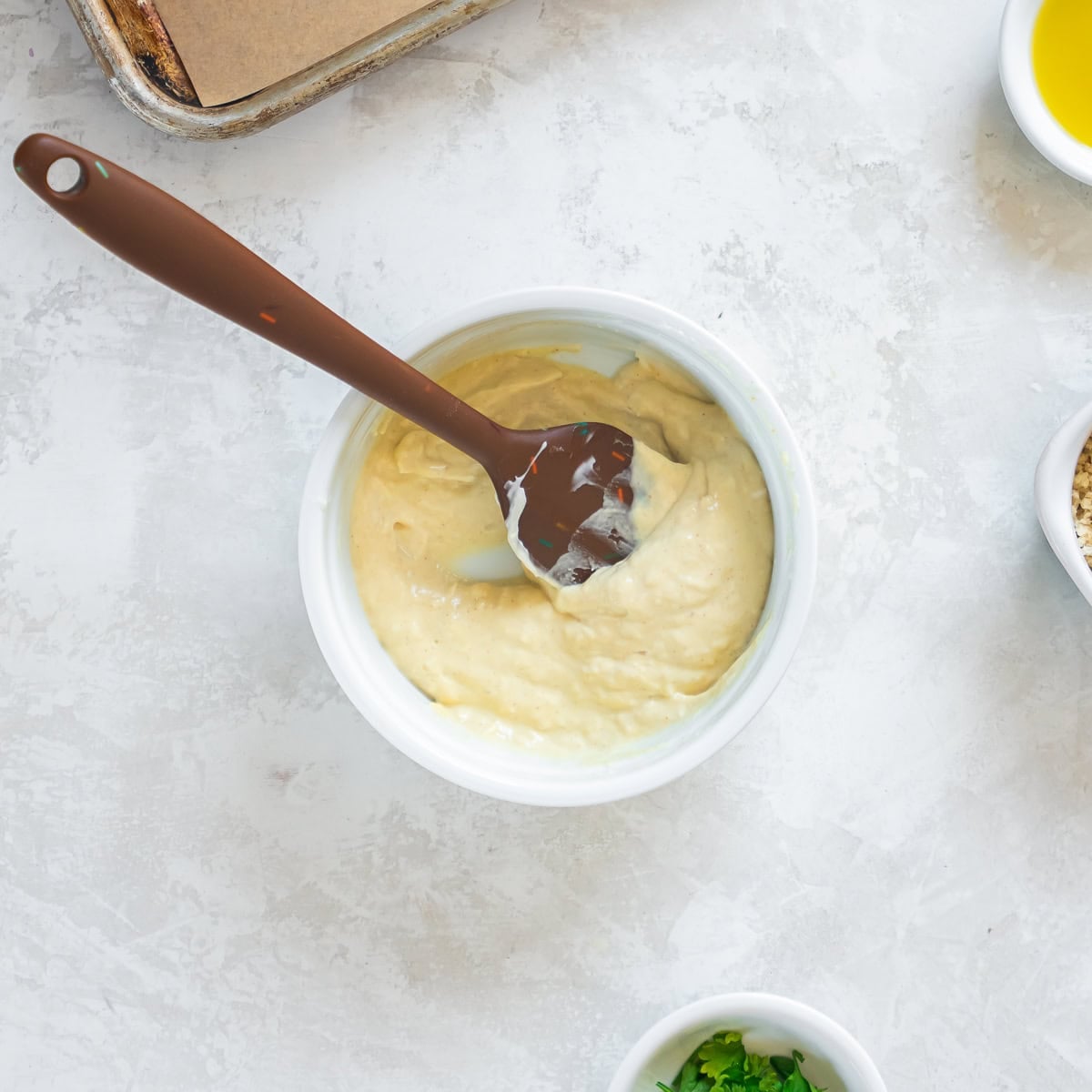 Creamy mayonnaise mixture with Dijon mustard and lemon juice in a bowl, stirred until smooth.