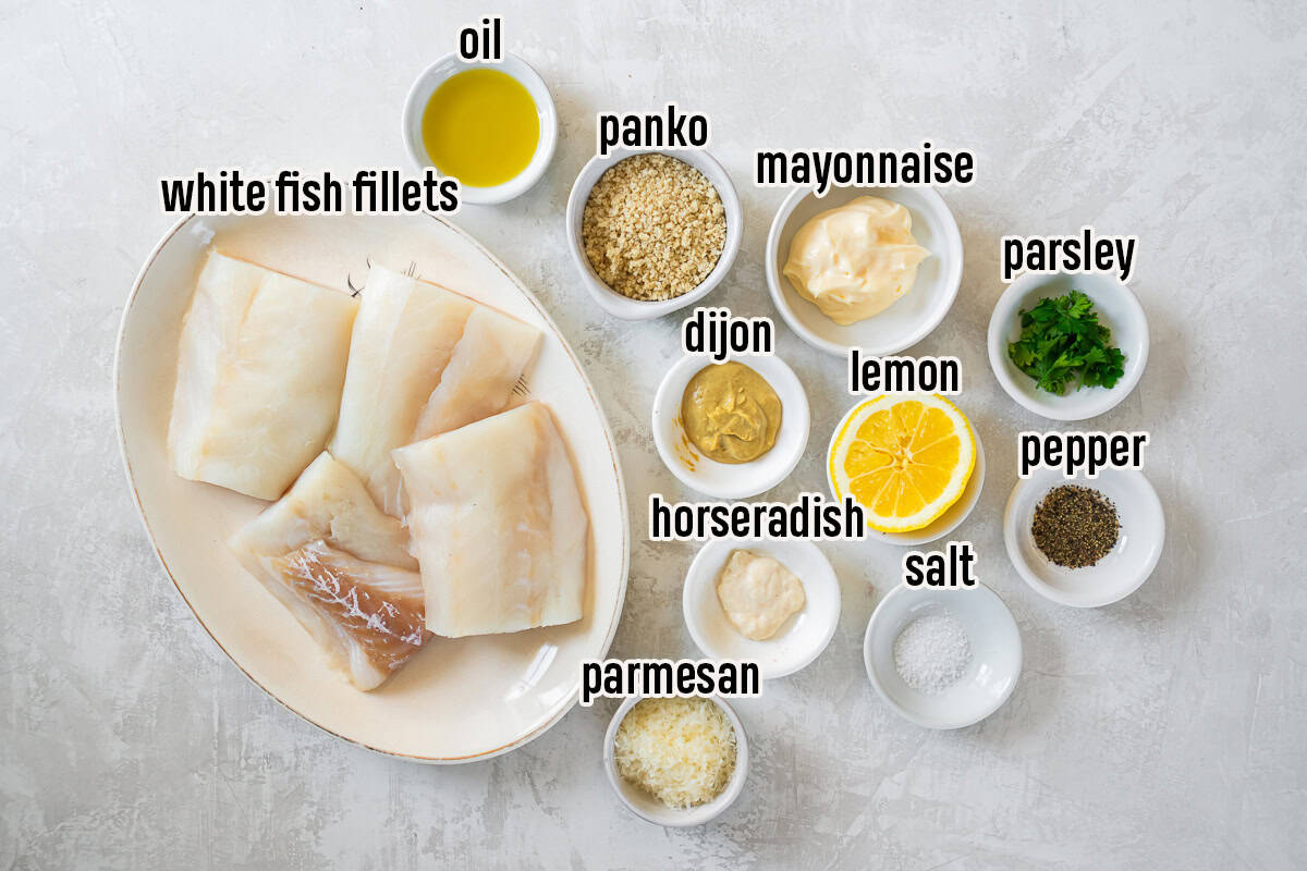 Ingredients for Parmesan Crusted Fish including white fish fillets, mayonnaise, Dijon mustard, horseradish, lemon, Parmesan cheese, panko breadcrumbs, parsley, olive oil, salt, and pepper.