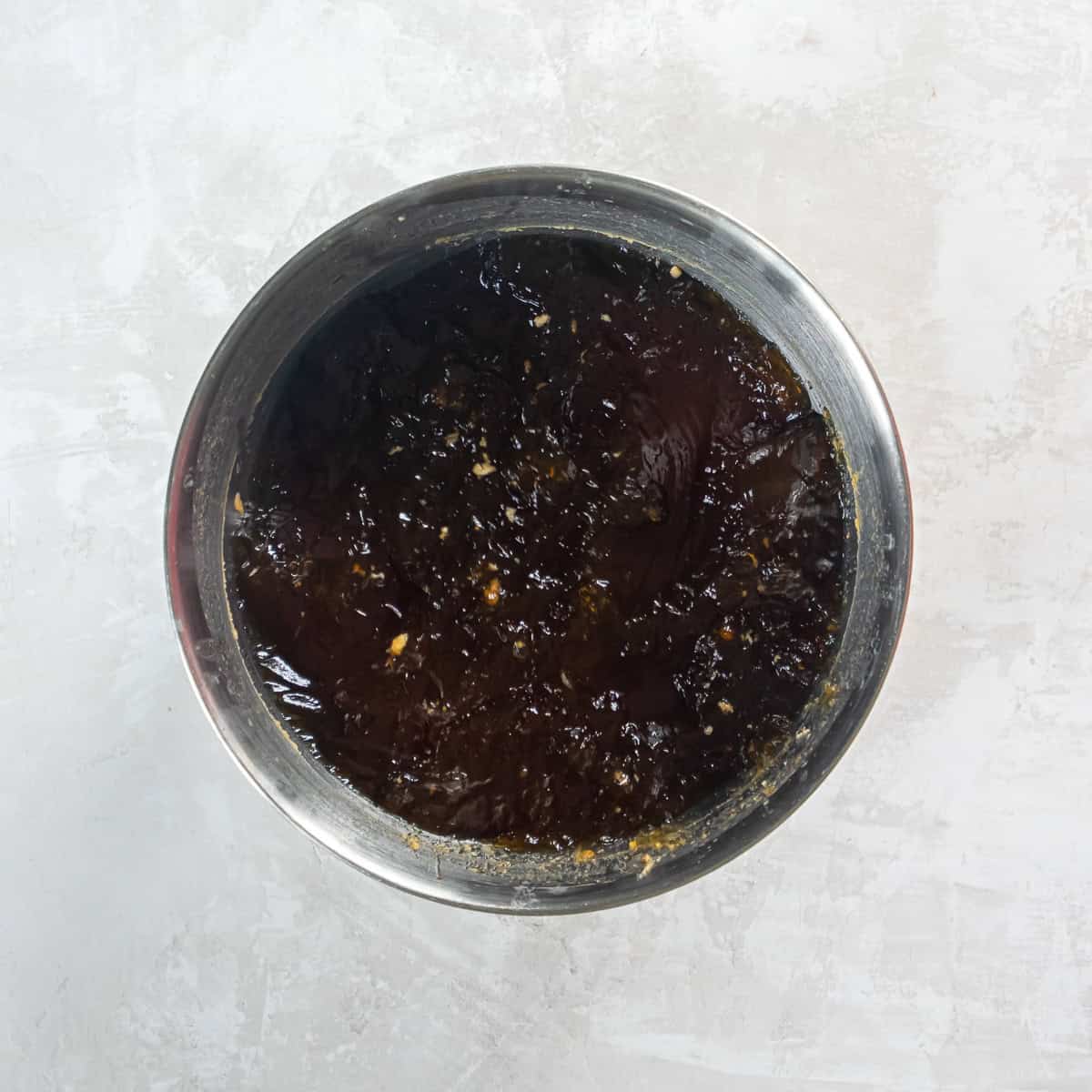 Defatted cooking liquid in a bowl.