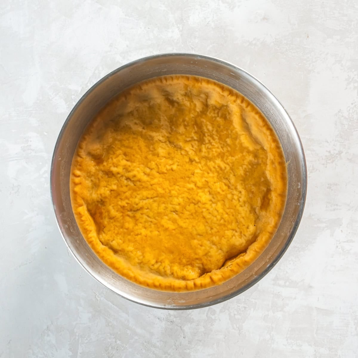 Chilled cooking liquid with a solid layer of fat on the surface.