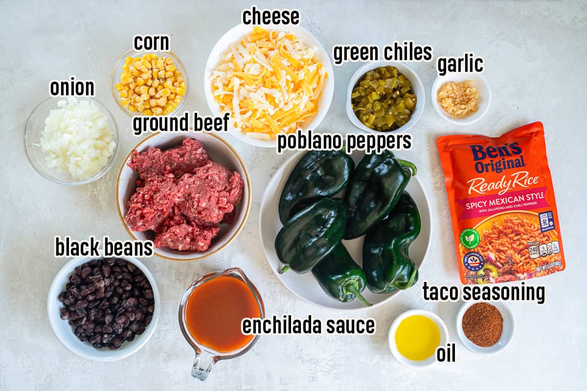 Ingredients for stuffed poblano peppers including ground beef, black beans, corn, cheese, enchilada sauce, and poblano peppers.