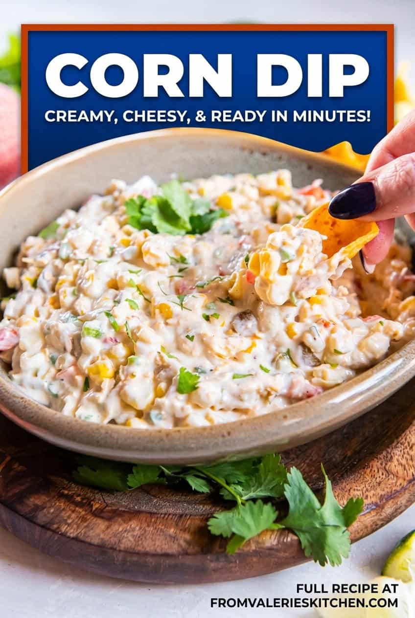 A chip scooping creamy corn dip made with cheddar cheese, green chiles, jalapeño, and frozen corn with text overlay.