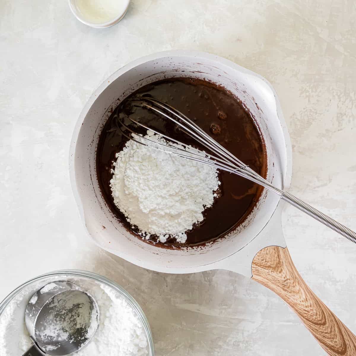 Powdered sugar added to the chocolate glaze mixture before whisking until smooth.