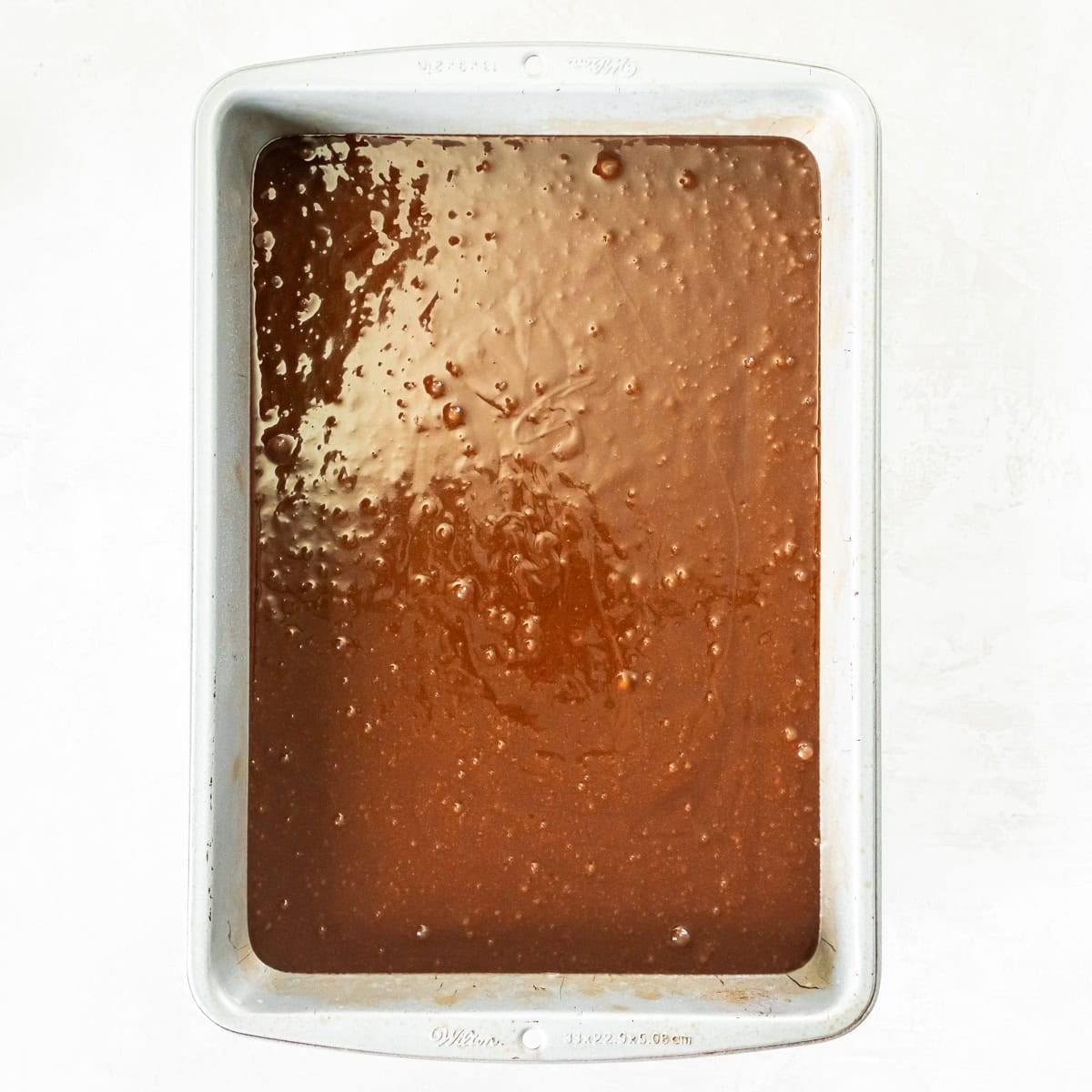 Coca-Cola Cake batter spread evenly in a 13- x 9-inch baking dish before baking.
