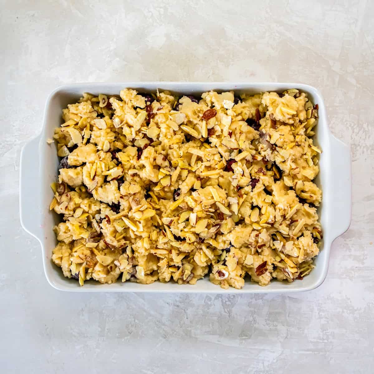 Fresh Cherry Cobbler topped with sliced almonds before baking.