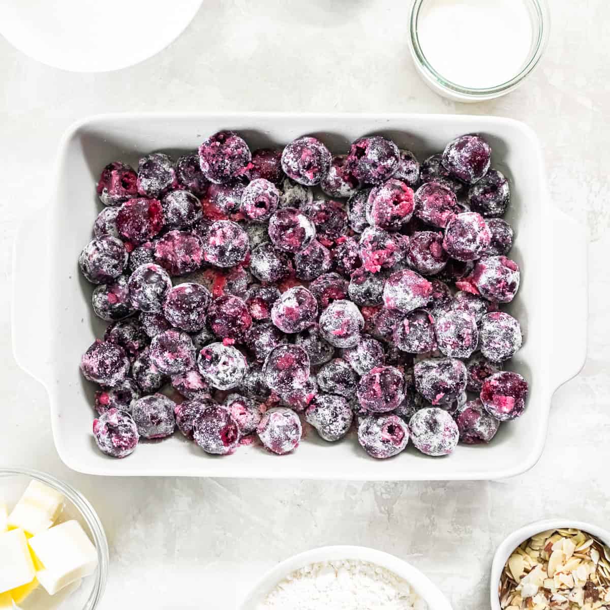 Fresh cherry filling spread in a baking dish before adding the cobbler topping.