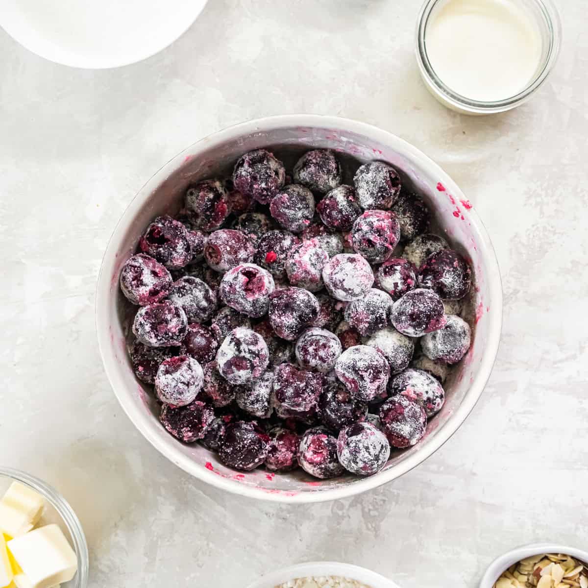 Fresh dark sweet cherries tossed with sugar and flour for Fresh Cherry Cobbler.