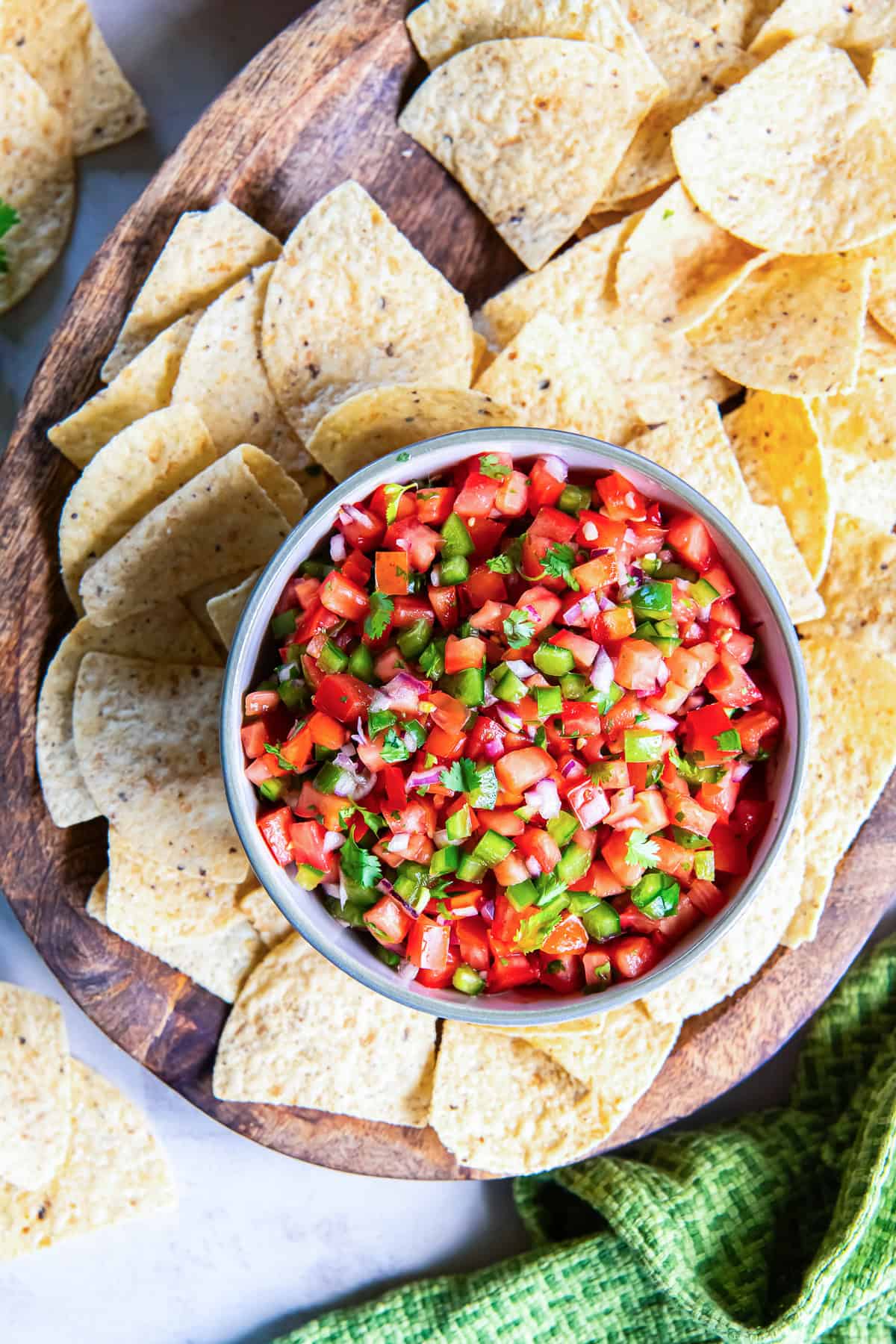 Bowl of fresh tomato salsa surrounded by tortilla chips.