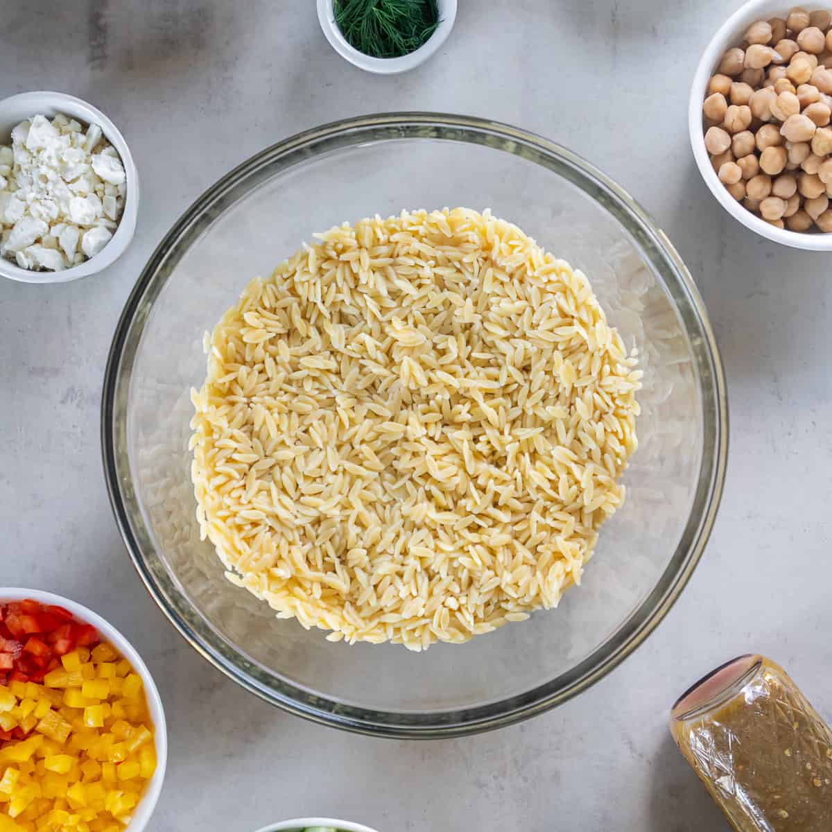 Cooked orzo in a glass bowl.