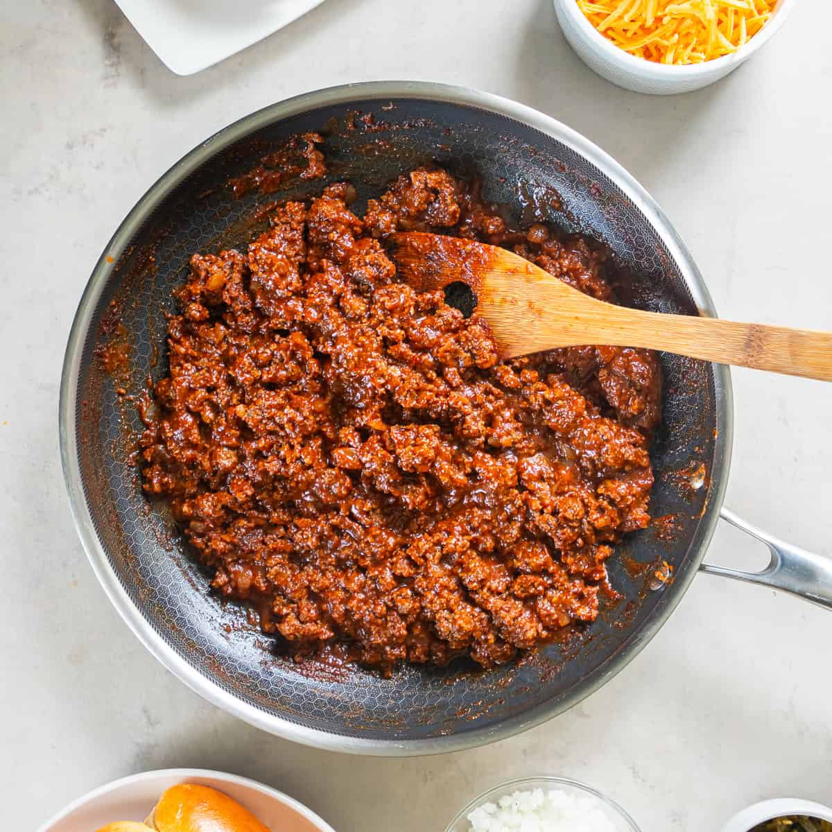 Thickened hot dog chili simmering in a skillet after cooking, ready to serve over hot dogs.