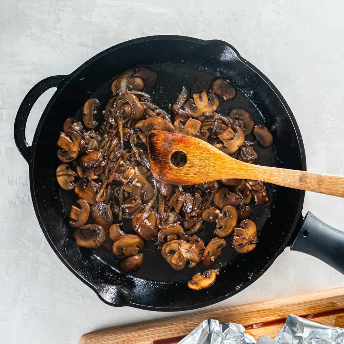 Sautéed mushrooms and onions in a cast iron skillet.