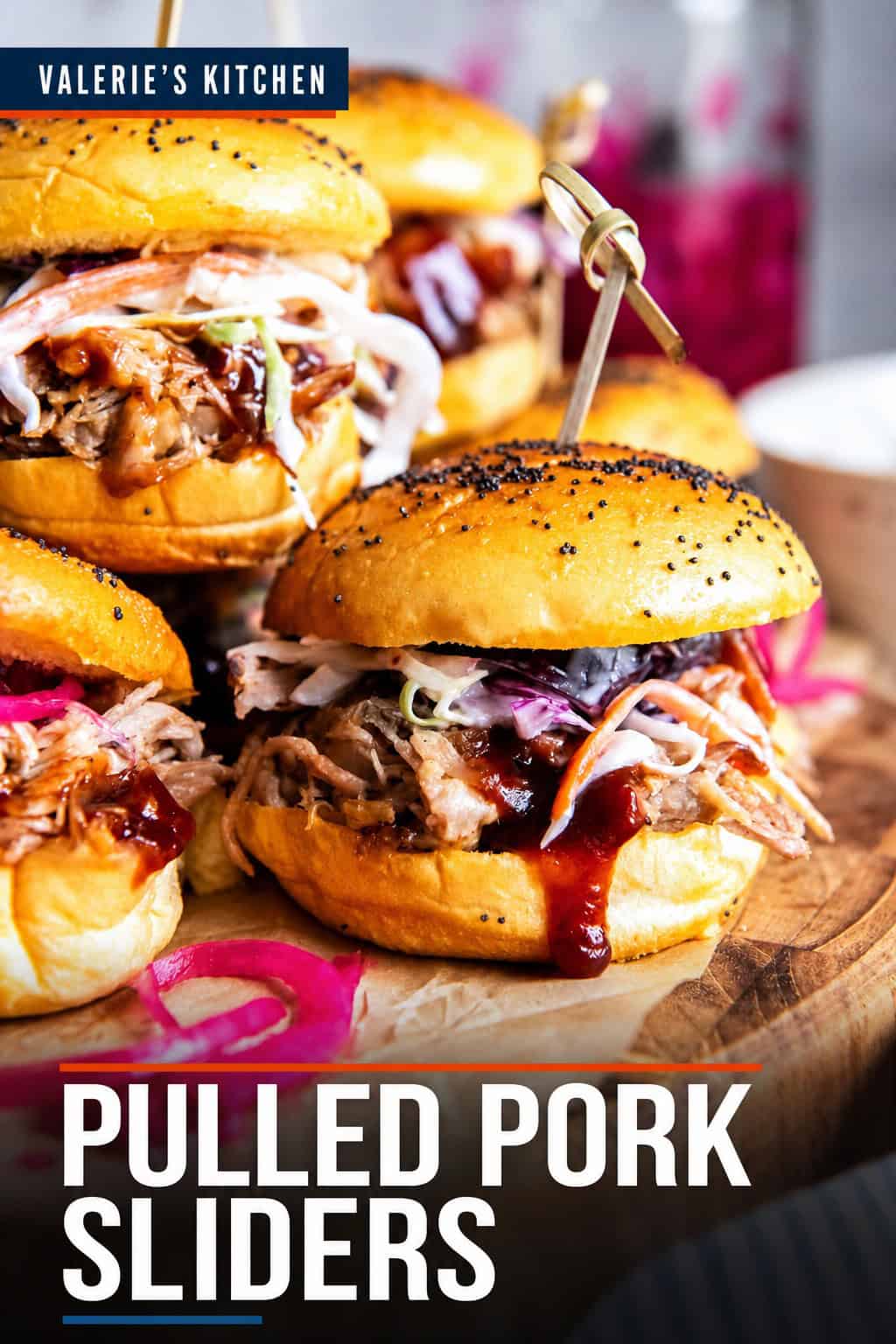 Pinterest graphic featuring Pulled Pork Sliders on toasted slider rolls topped with coleslaw, pickled onions, and BBQ sauce. The graphic includes the text “Pulled Pork Sliders.”