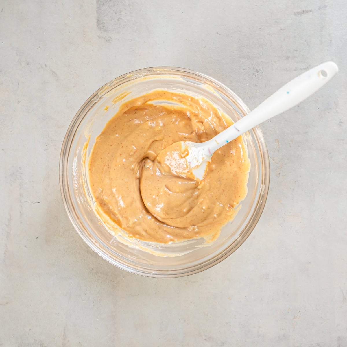 Burger sauce mixed until smooth in a glass bowl with a spatula.