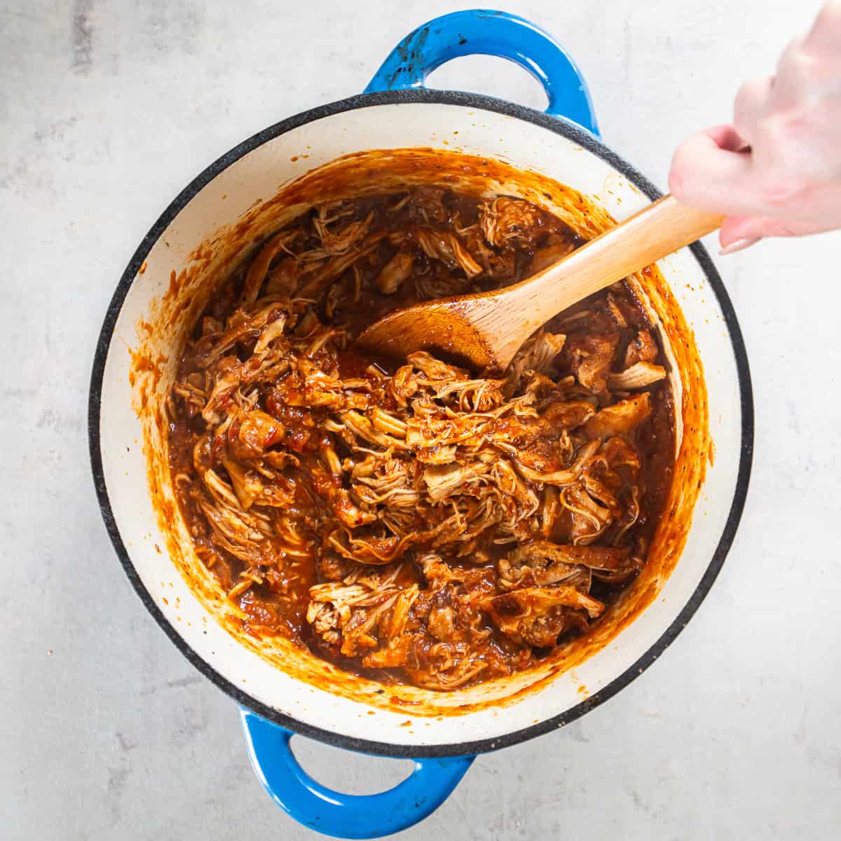 Shredded chicken stirred into the blended chipotle tomato sauce to make Chicken Tinga.