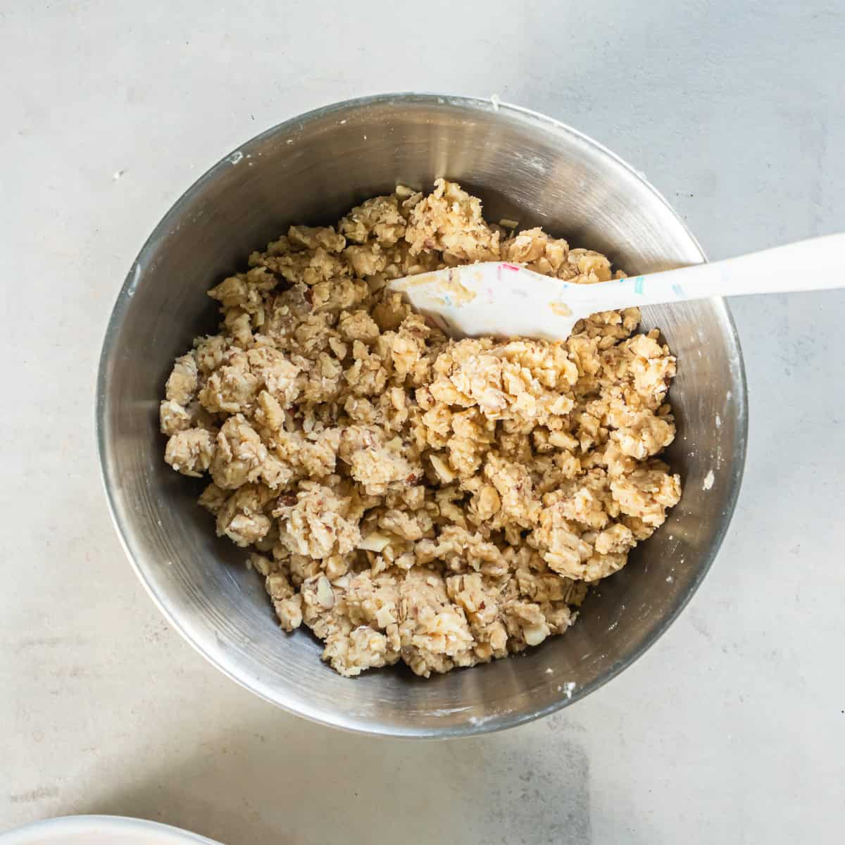 Mixed oat and almond crisp topping with a crumbly texture.