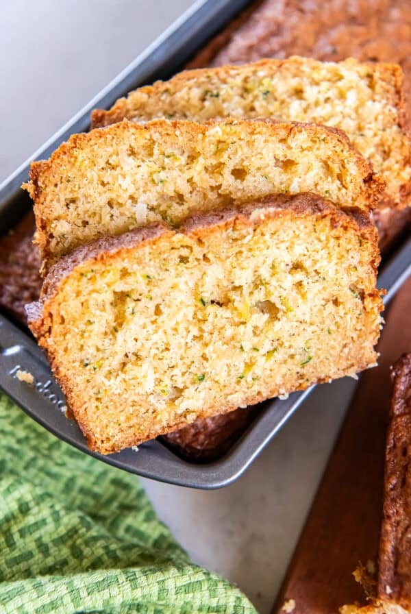 Sliced pineapple zucchini bread with a soft, moist crumb and bits of fresh zucchini throughout.