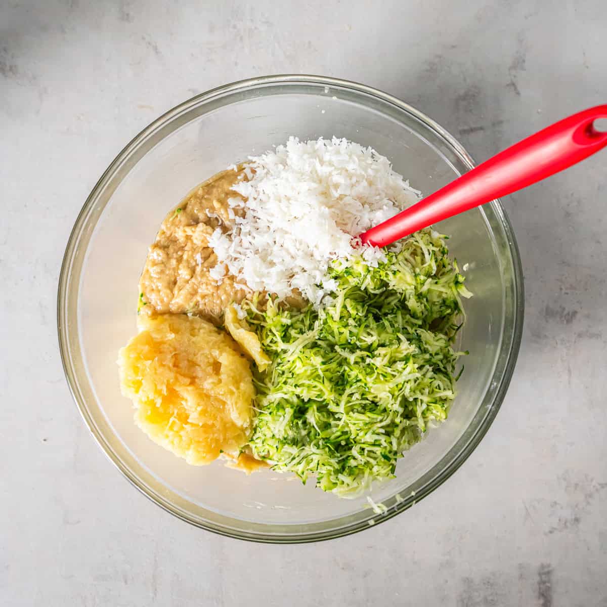 Shredded zucchini, crushed pineapple, and sweetened coconut added to the Pineapple Zucchini Bread batter.